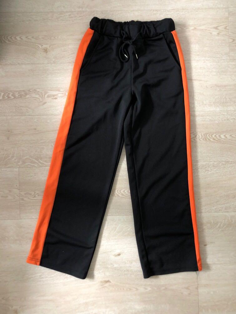 orange and black track pants