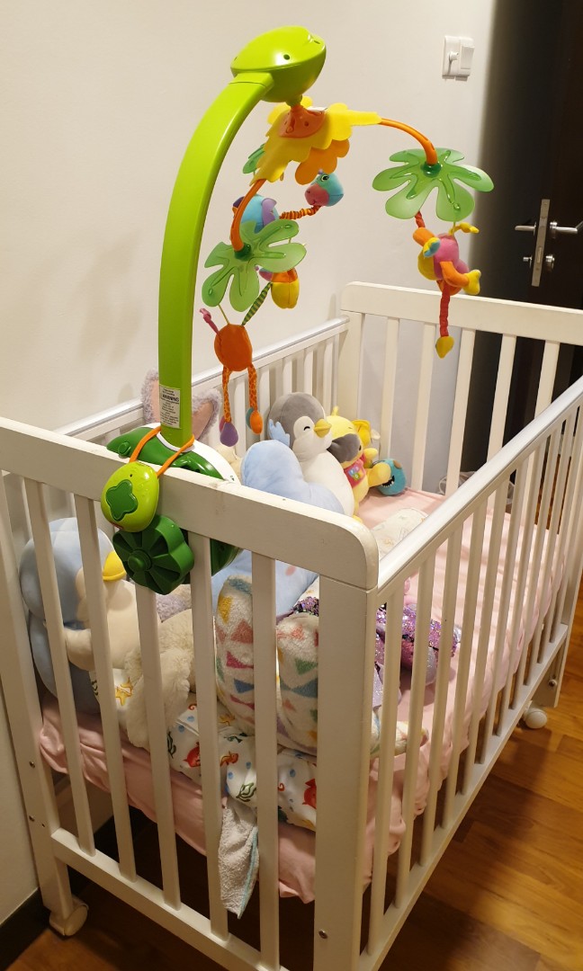 white wooden baby cot