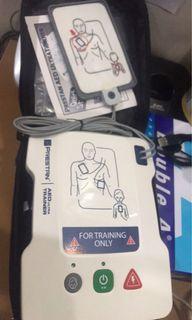 on hand Prestan AED Trainer for manikin 
