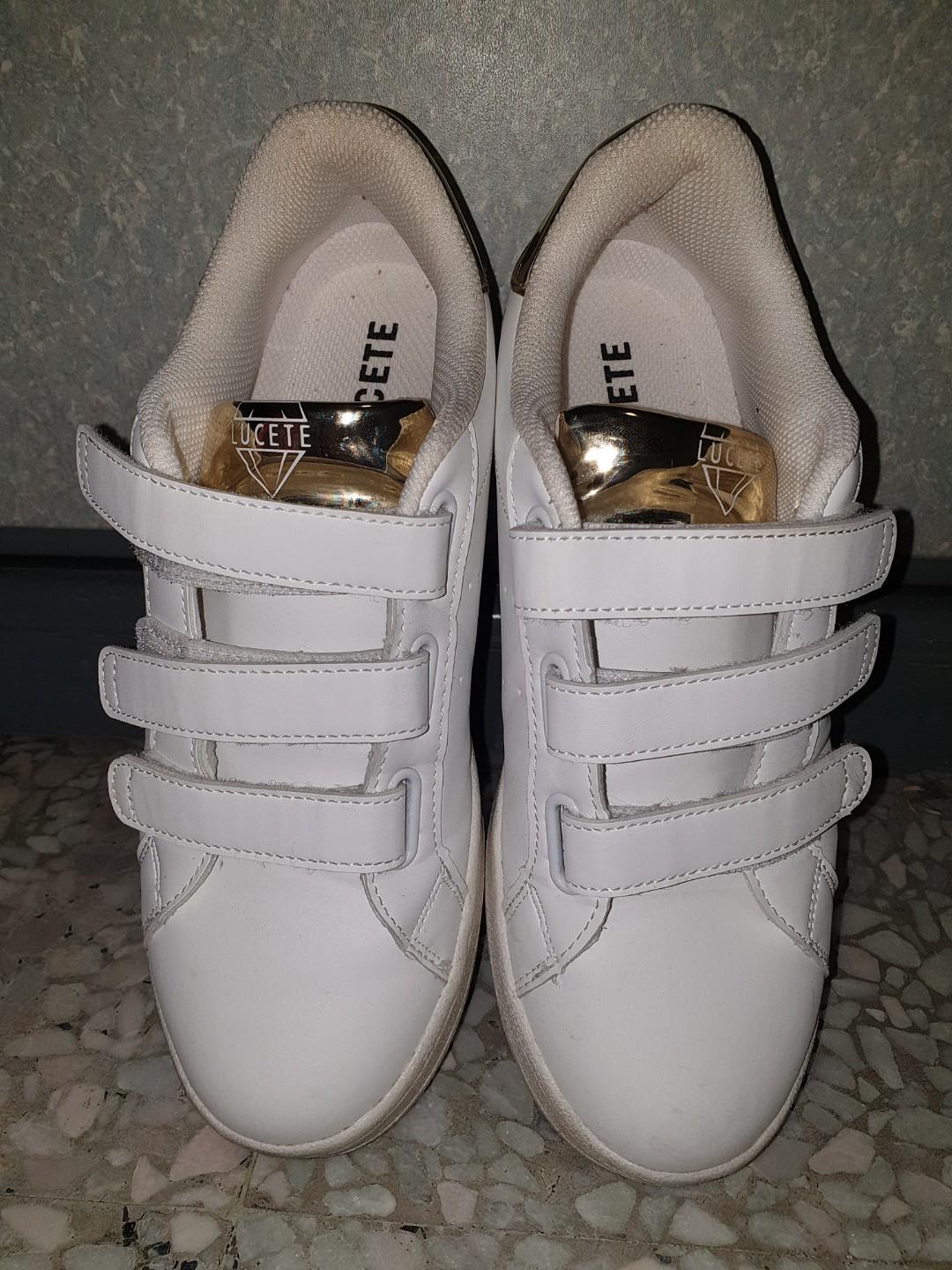 white and gold gym shoes