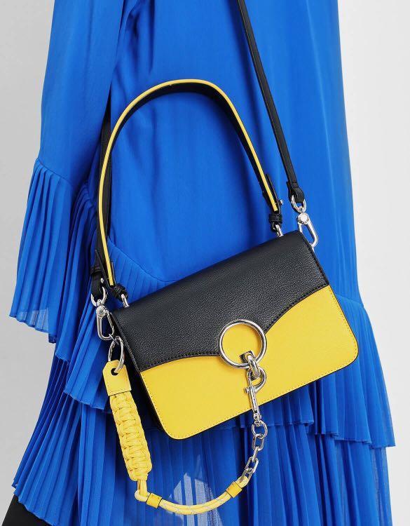 Black bag top with yellow strap