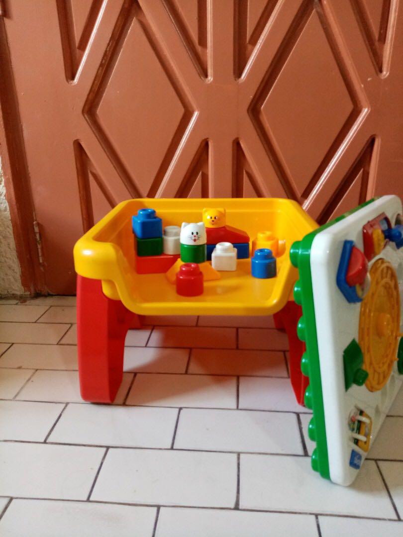 FLIP AND PLAY ACTIVITY TABLE (Category: Infant Playtime) located in Pasig City. Submitted by rxjmn (Listing ID 233772803, Image 3). Description: #BEST2019 **100 PESOS OFF when you pair this with any item in my catalog! Ideal for stimulating child's coordination and education skills with multi-activities. Comes with 3 letter /number blocks, 2 Character blocks, and 12 building blocks. (Toy phone and train missing, but other parts are still in good 