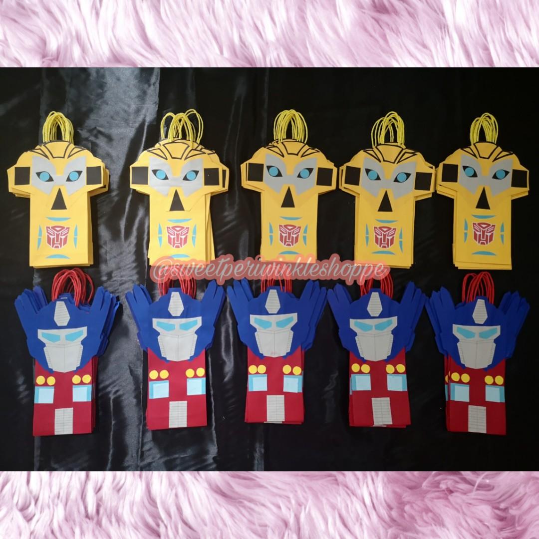 Made to Order Transformers Loot Bags (Category: Character Goods) located in Taguig. Submitted by sweetperiwinkleshoppe (Listing ID 254883793, Image 3). Description: READ ME PLEASE: 🦄LOOT BAGS PRICE LIST 🌻 25php PER piece 🌻min of 20pcs to order 🌻min of 4pcs per design 🌻 addtl 3php PER piece for "Thank You" tag Size: L - 5" H - 10" W - 2" THANK YOU!🙂🙂🙂 #transformers #paperbags #favorbags #partybags #lootbags #bumblebee #optimusprime #madeto