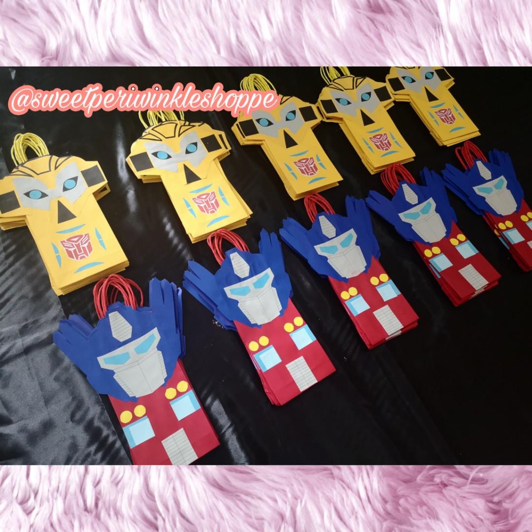 Made to Order Transformers Loot Bags (Category: Character Goods) located in Taguig. Submitted by sweetperiwinkleshoppe (Listing ID 254883793, Image 2). Description: READ ME PLEASE: 🦄LOOT BAGS PRICE LIST 🌻 25php PER piece 🌻min of 20pcs to order 🌻min of 4pcs per design 🌻 addtl 3php PER piece for "Thank You" tag Size: L - 5" H - 10" W - 2" THANK YOU!🙂🙂🙂 #transformers #paperbags #favorbags #partybags #lootbags #bumblebee #optimusprime #madeto