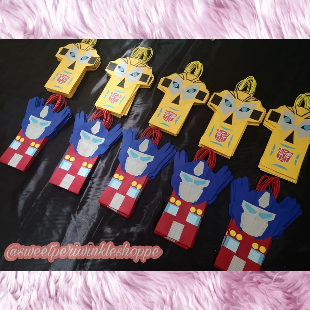 Made to Order Transformers Loot Bags (Category: Character Goods) located in Taguig. Submitted by sweetperiwinkleshoppe (Listing ID 254883793, Image 1). Description: READ ME PLEASE: 🦄LOOT BAGS PRICE LIST 🌻 25php PER piece 🌻min of 20pcs to order 🌻min of 4pcs per design 🌻 addtl 3php PER piece for "Thank You" tag Size: L - 5" H - 10" W - 2" THANK YOU!🙂🙂🙂 #transformers #paperbags #favorbags #partybags #lootbags #bumblebee #optimusprime #madeto
