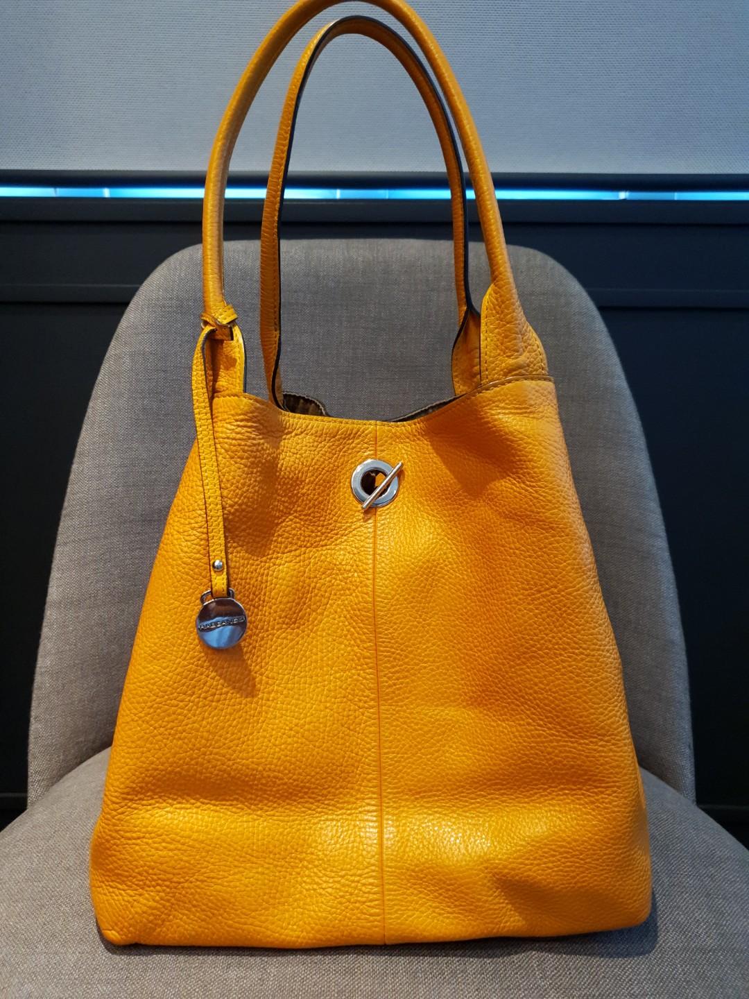 Mustard tote (Category: Tote Bags) located in Mandaluyong City. Submitted by secondipity111 (Listing ID 256068675, Image 1). Description: Rabeanco Alex large tote Classic collection Zipped pouch included Restored and conditioned by Doctor Leather Slightly used.