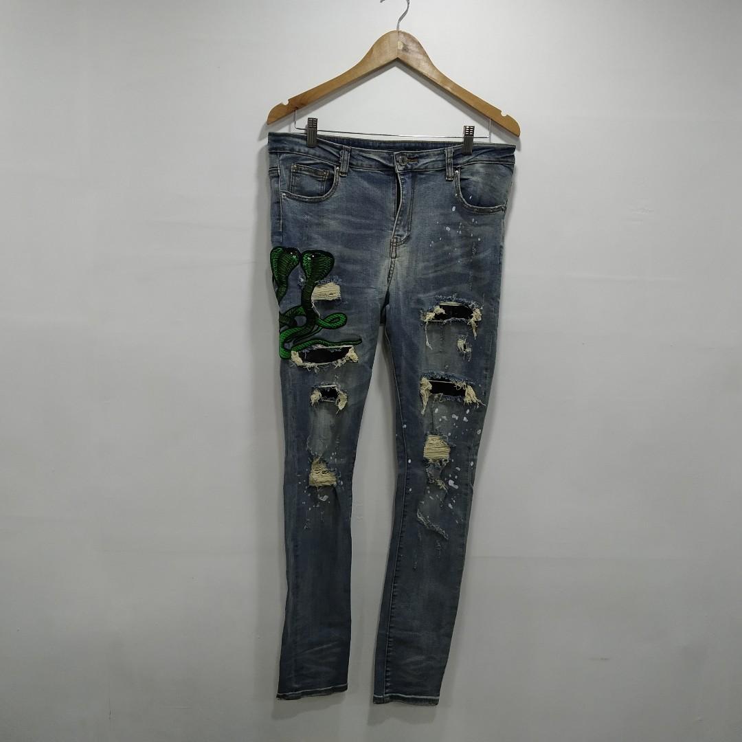 amiri jeans with green snake