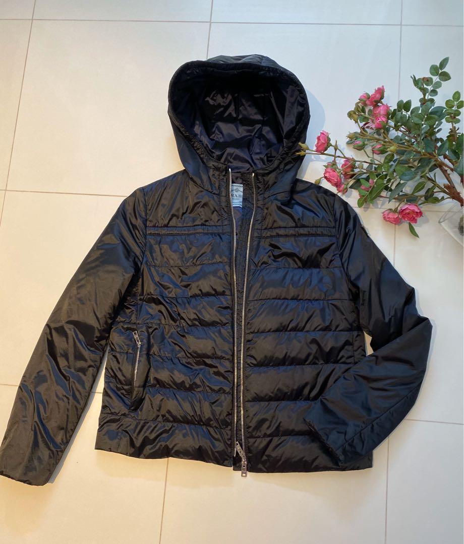 PRADA Down Jacket (Category: Apparel) located in Singapore. Submitted by ts2008 (Listing ID 257527920, Image 1). Description: ITEM ON HOLD till June 2024 100% Authentic Colour: Navy/Blue Conditions: like new (but some scratches on zipper pull Style: Hooded down Jacket with 2 inner and outer pockets. Light weight Pls refer to last photo for measurements. Bought from Japan Gotemba . Comes with original receipt and product tag .