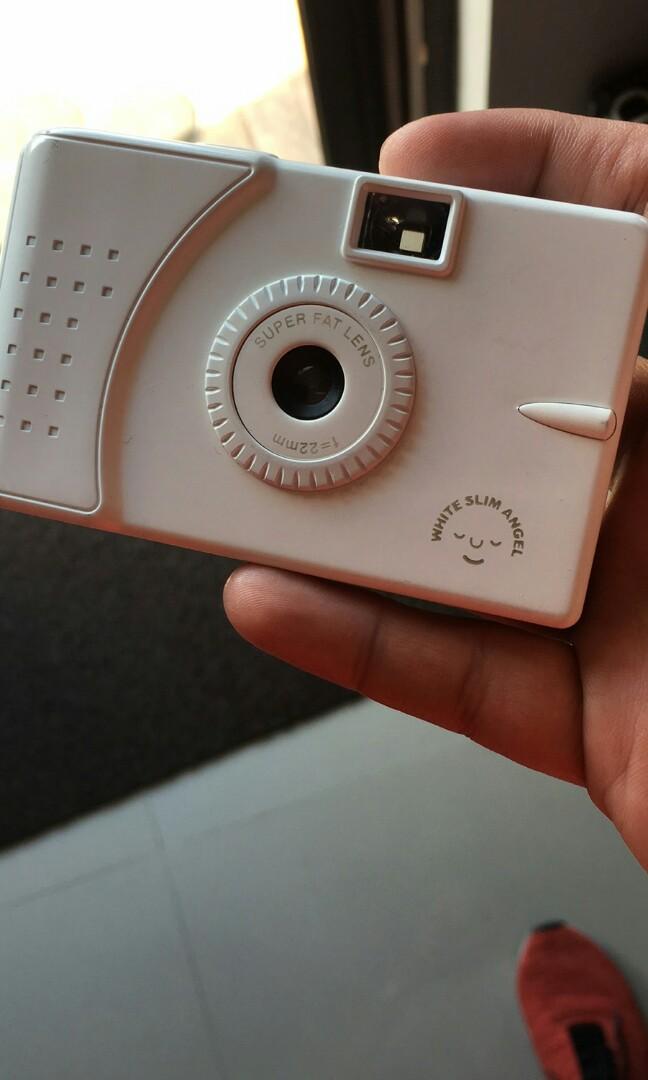 White Slim Angel Slim Wide Angle Camera. (Category: Cameras) located in Orani. Submitted by mrhobbyshop (Listing ID 258193567, Image 1). Description: Old New Stock. No box. Never used. White Slim Angel Slim Wide Angle Camera. Shoot dynamic, wide-world pictures with its 22mm wide-angle lens! Surprisingly vivid colours! Charming pictures, lovely vignetting (tunnel effect)! 35mm Film Format. When Vivitar discontinued these we picked up the mantle on