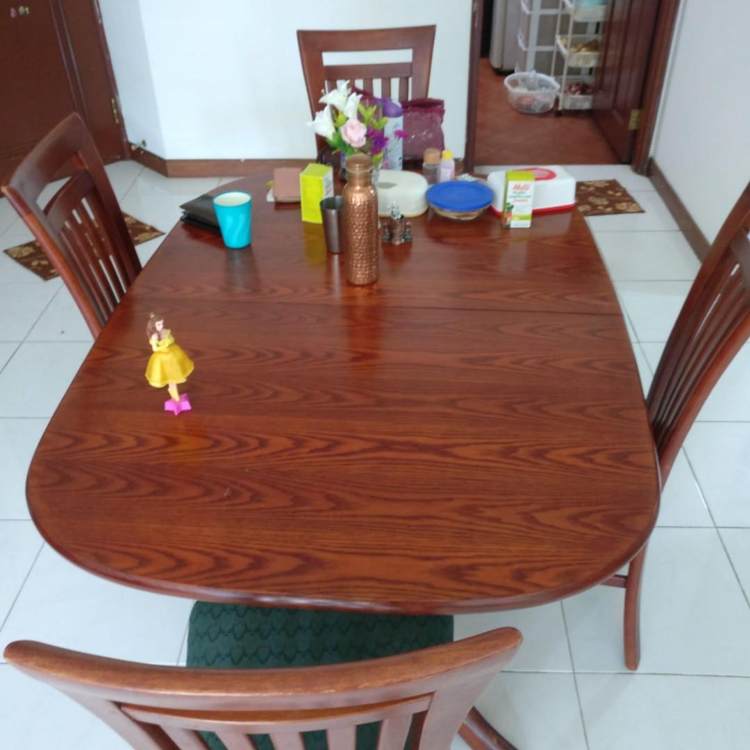 Dining Table (Category: Tables & Sets) located in Singapore. Submitted by taruna81 (Listing ID 259187640, Image 1). Description: Solid wood dining table in good condition with 5 cushioned chairs.