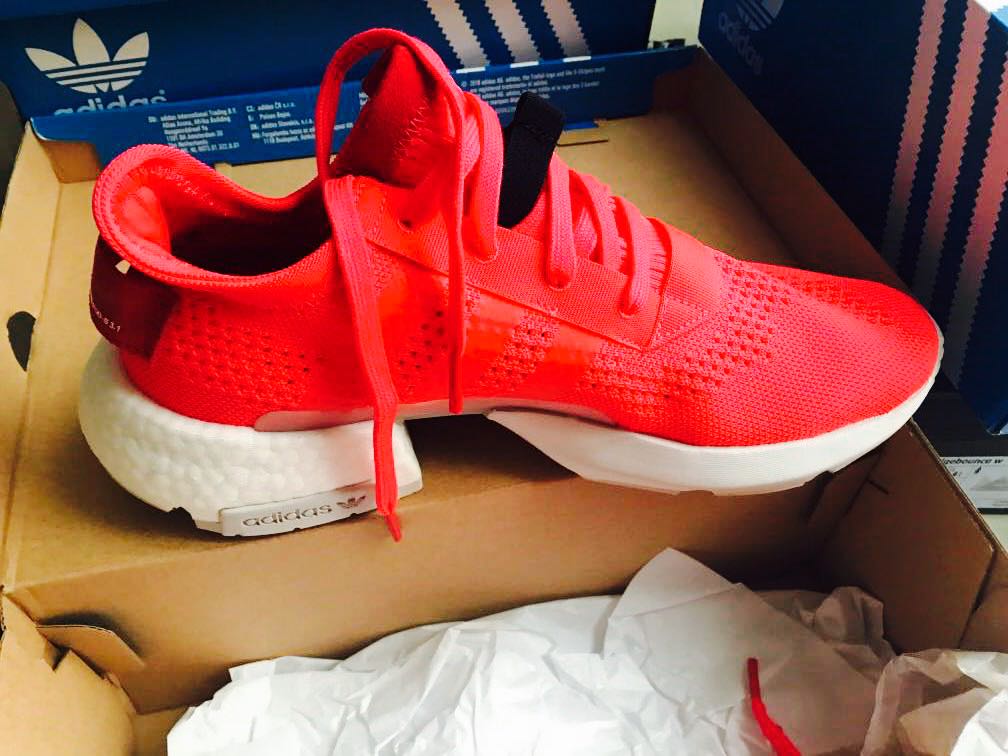 pink and red adidas sneakers