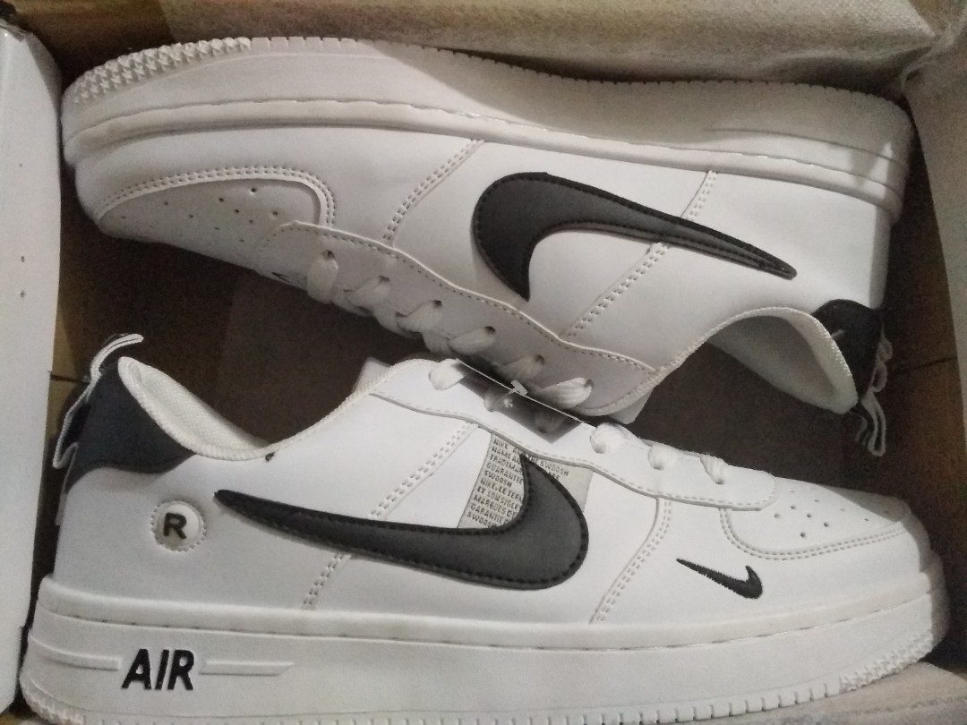 white nike shoes with black nike sign