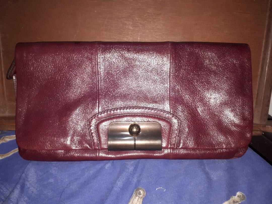 Coach leather clutch (maroon/burgundy) (Category: Luxury Bags & Wallets) located in Quezon City. Submitted by prelovedqualitycloset (Listing ID 262329084, Image 1). Description: > Authentic Coach clutch > Maroon/ burgundy leather > Fuschia satin lining > 1 open compartment w/ zip pocket > 1 zipped compartment with 2 pockets > Great used condition (with some light scratches) > inches: 13.5 x 7 x 1 > cm: 34.5 x 18 x 2.5 > RFS: I don't get to use it