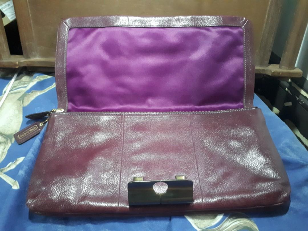 Coach leather clutch (maroon/burgundy) (Category: Luxury Bags & Wallets) located in Quezon City. Submitted by prelovedqualitycloset (Listing ID 262329084, Image 3). Description: > Authentic Coach clutch > Maroon/ burgundy leather > Fuschia satin lining > 1 open compartment w/ zip pocket > 1 zipped compartment with 2 pockets > Great used condition (with some light scratches) > inches: 13.5 x 7 x 1 > cm: 34.5 x 18 x 2.5 > RFS: I don't get to use it