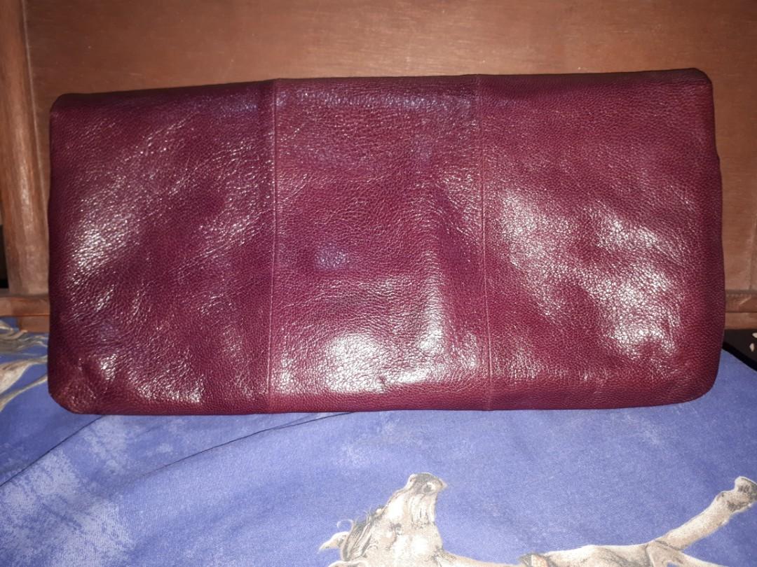 Coach leather clutch (maroon/burgundy) (Category: Luxury Bags & Wallets) located in Quezon City. Submitted by prelovedqualitycloset (Listing ID 262329084, Image 2). Description: > Authentic Coach clutch > Maroon/ burgundy leather > Fuschia satin lining > 1 open compartment w/ zip pocket > 1 zipped compartment with 2 pockets > Great used condition (with some light scratches) > inches: 13.5 x 7 x 1 > cm: 34.5 x 18 x 2.5 > RFS: I don't get to use it