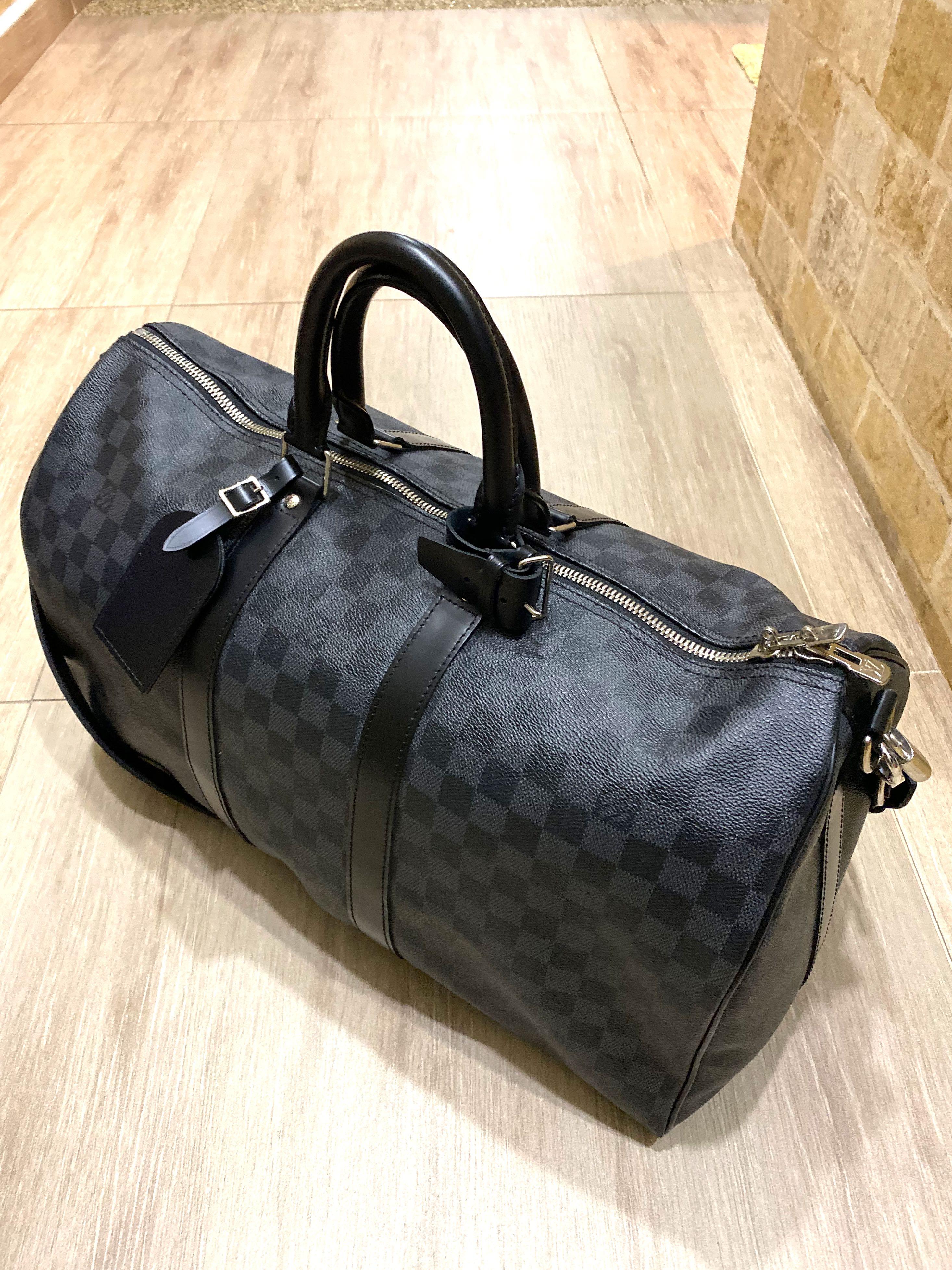 Sold at Auction: A designer duffle bag marked Louis Vuitton with dust bag,  strap & luggage tag
