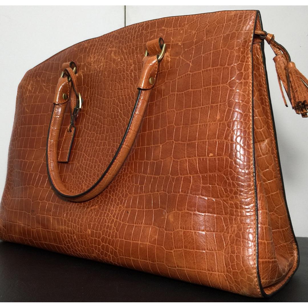 FINO Leather Handbag (Category: Tote Bags) located in Manila. Submitted by ina_44 (Listing ID 264555025, Image 1). Description: Dark Orange/Tan FINO Leather Handbag with black case as seen in picture. TEXT ONLY FOR INQUIRIES.