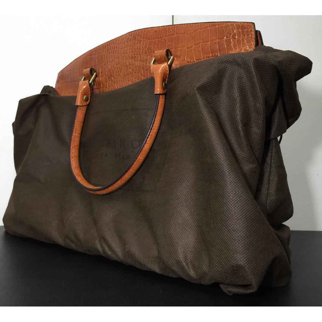 FINO Leather Handbag (Category: Tote Bags) located in Manila. Submitted by ina_44 (Listing ID 264555025, Image 2). Description: Dark Orange/Tan FINO Leather Handbag with black case as seen in picture. TEXT ONLY FOR INQUIRIES.