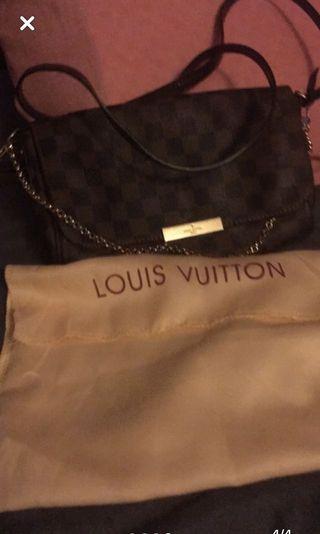 Louis Vuitton cross body bag with magnet closure