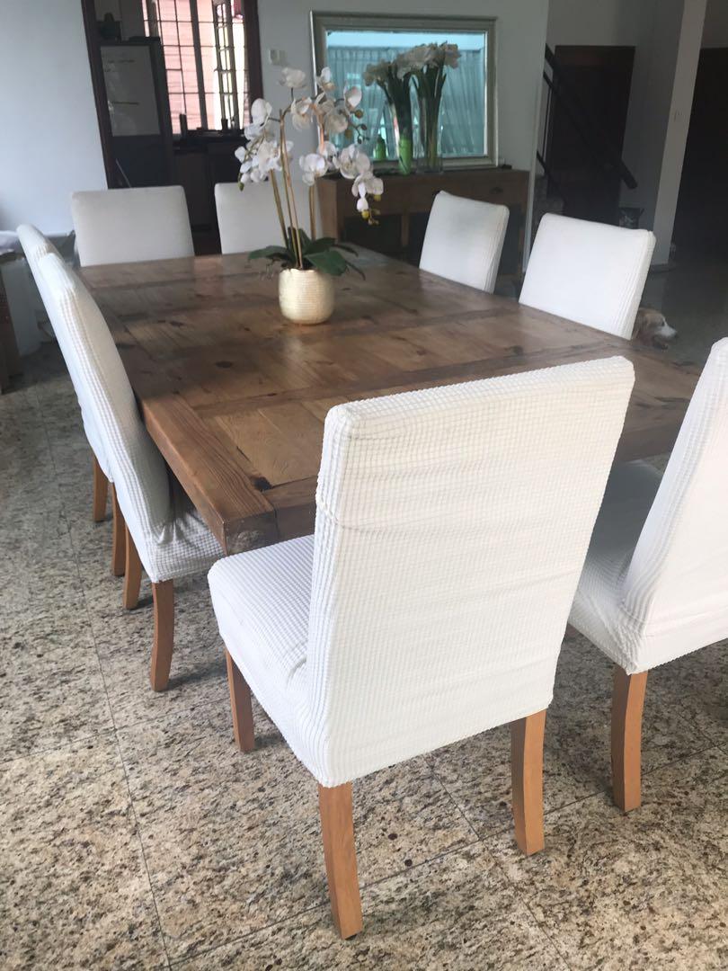 Dining Table (Category: Tables & Sets) located in Singapore. Submitted by jmp71 (Listing ID 267231681, Image 1). Description: Beautiful and solid wood. Some wood worn underneath from dog chewing. 8 Chairs in good condition. I have put covers on them otherwise it’s a red and white check material underneath. L = 220cm W = 120cm Collection only in January. .