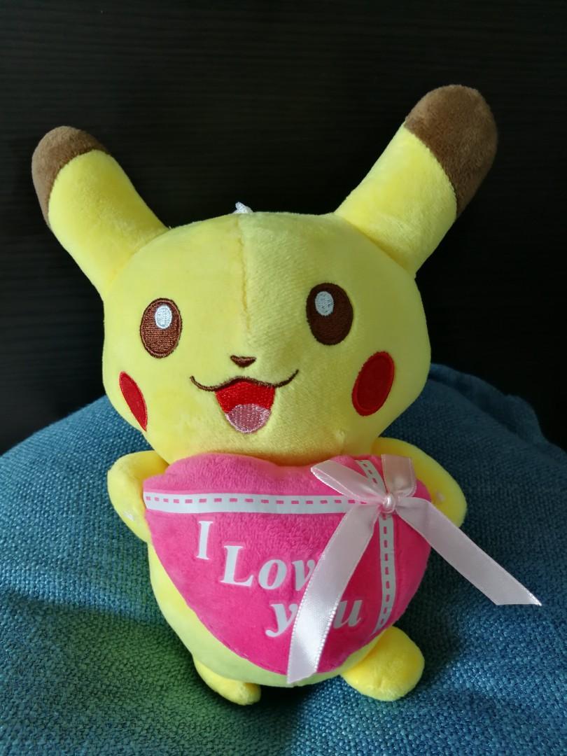 pikachu holding a heart plush