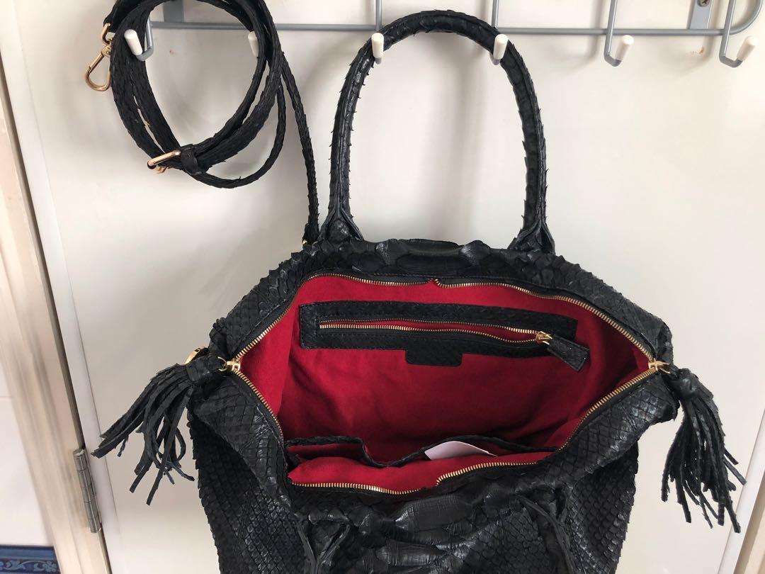 IKI Black Python Bag (Category: Cross-body Bags) located in Singapore. Submitted by redpeeps (Listing ID 268680437, Image 4). Description: Condition: 9/10, seldom used Beautiful roomy bag in black jumbo python leather with gorgeous red suede fabric interior and gold hardware. Interior has 3 pockets. Versatile styling as it comes with a fixed handle (16cm drop) and a detachable 90cm shoulder strap. Measurement: W 30/45cm x H 29cm x D 17cm Fits a 1