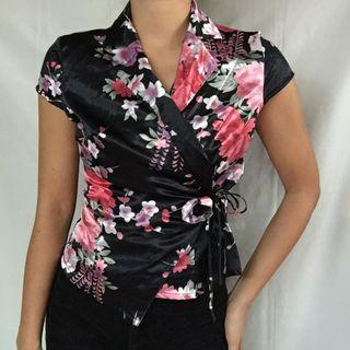 Black cheongsam wrap top in pink, white, green, and purple floral pattern