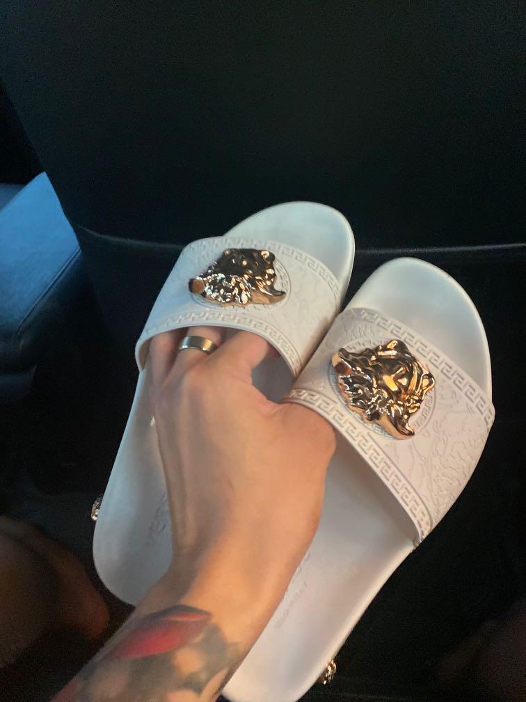 Versace white slides with gold head on the front and the sides of the slides