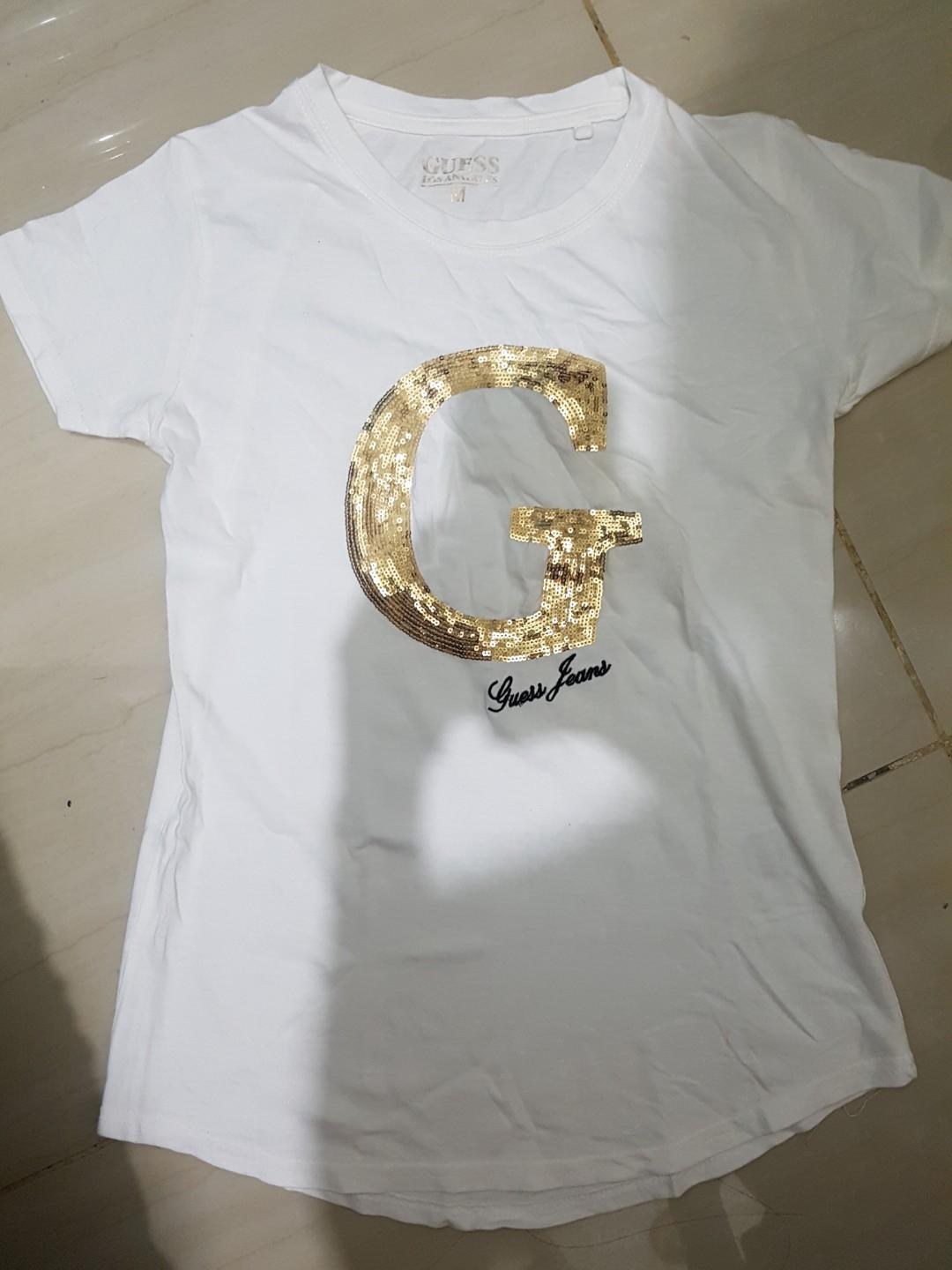 gold and white guess shirt