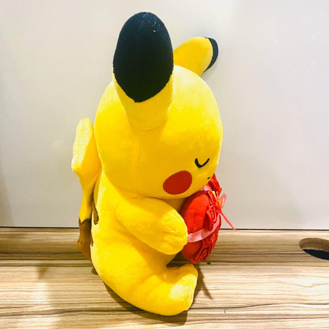Pikachu holding a heart plush deals