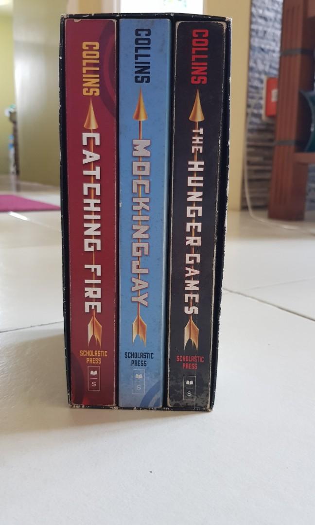 The Hunger Games Trilogy by Suzanne Collins (Category: Storybooks) located in Mandaluyong City. Submitted by fiogurt (Listing ID 275658803, Image 2). Description: Selling my pre-owned The Hunger Games book Trilogy by Suzanne Collins. Only read once, still in great condition. Pages are naturally yellowed with age. Includes cardboard box case. Message me if you're interested. May the odds be ever in your favor!.