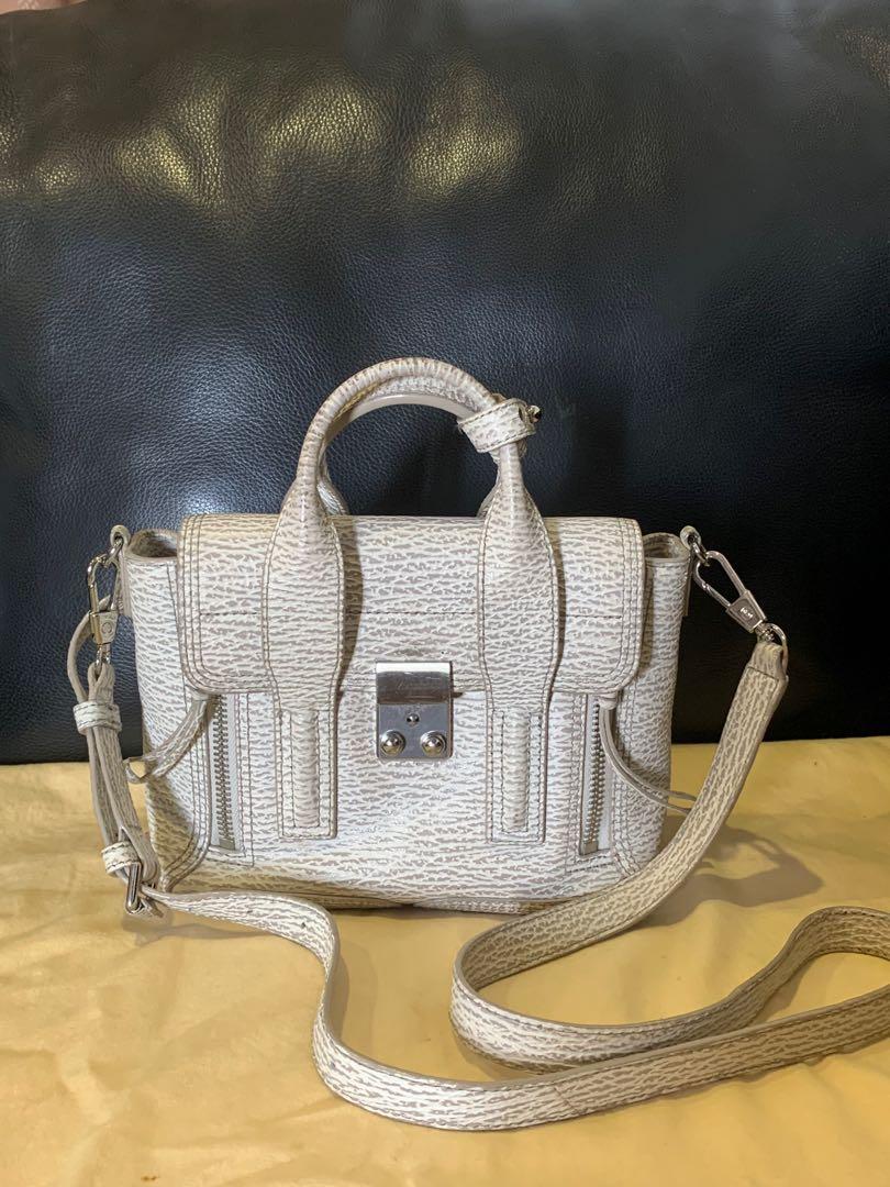 Philip Lim Pashli mini (Category: Luxury Bags & Wallets) located in Pasig City. Submitted by r.dizon (Listing ID 277366018, Image 2). Description: Ivory/Dove Shark Embossed Leather Mini Pashli Satchel Bag Silver Hardware This practical, yet elegant mini Pashli satchel bag will win your heart over with its irresistible style. Featuring grained leather, this shrunken down version of the Pashli bag has a long adjustable leather strap to be worn over