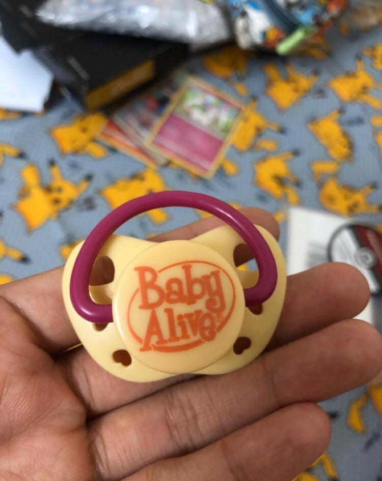 Baby alive with pacifier top