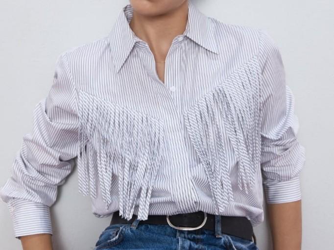 Zara Poplin Blouse Fringe Front (Category: Blouses) located in Makati City. Submitted by fromthetreasury (Listing ID 278849203, Image 2). Description: Collared long-sleeved polo with fringe appliques. Button-up front covered by a placket. Cowgirl look. Color: Ecru/Black.