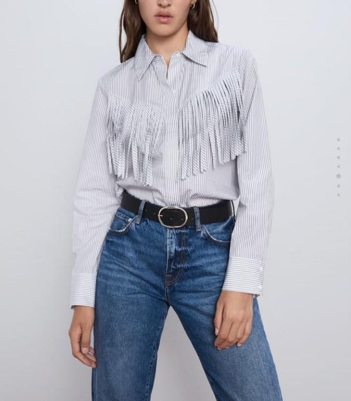 Zara Poplin Blouse Fringe Front (Category: Blouses) located in Makati City. Submitted by fromthetreasury (Listing ID 278849203, Image 1). Description: Collared long-sleeved polo with fringe appliques. Button-up front covered by a placket. Cowgirl look. Color: Ecru/Black.