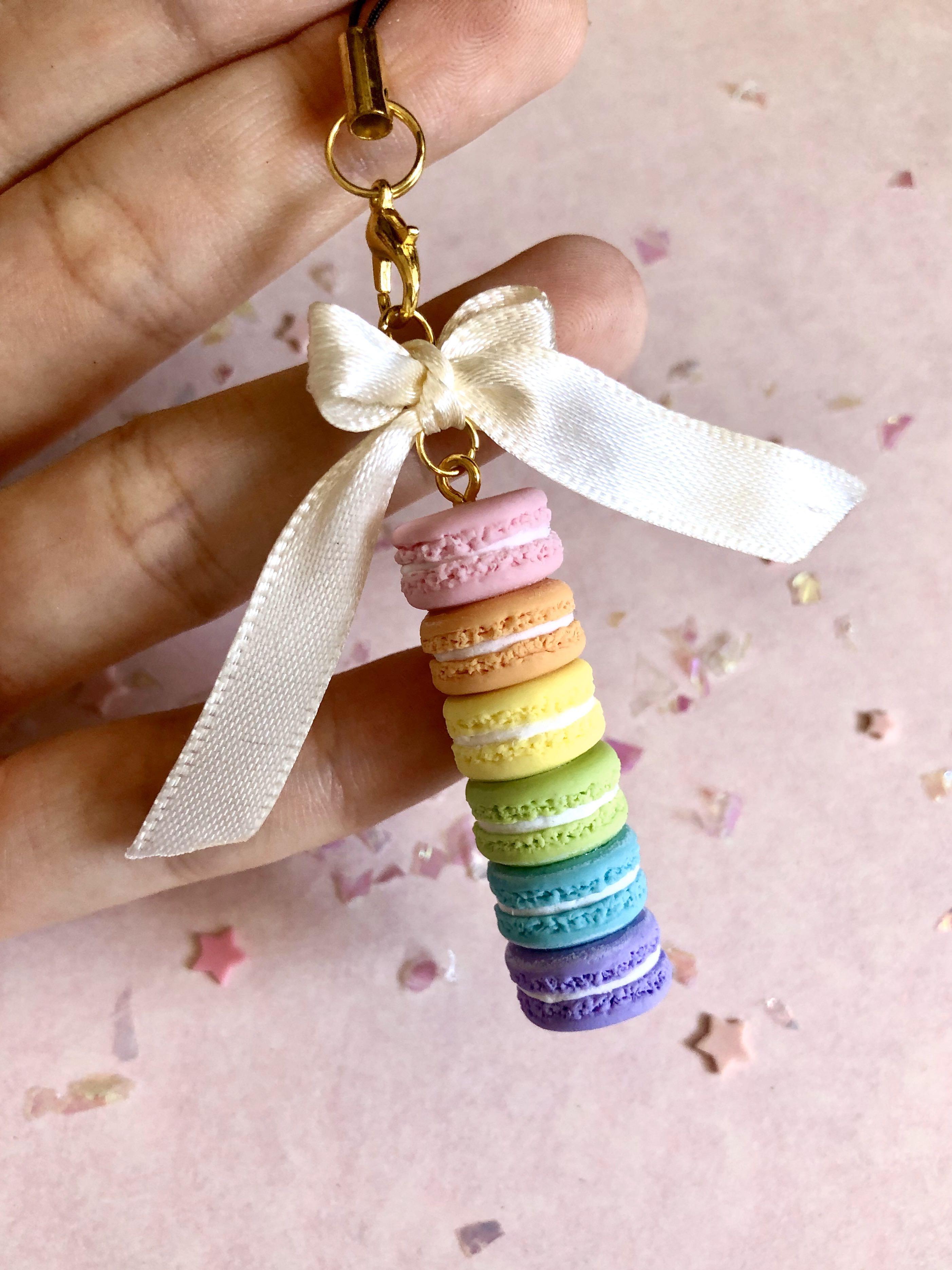Rainbow Macaron Stack Keychain (Category: Handmade Craft) located in Singapore. Submitted by shuningnong (Listing ID 279830113, Image 1). Description: • handmade with air dry clay • will be glazed to protect the charm from scratches and dirt • cellphone strap will be added upon purchase to turn the item into a keychain attachment: • bow --> +$1.00 note: bow colour can be varied, please send a message for more information :) although steps have be