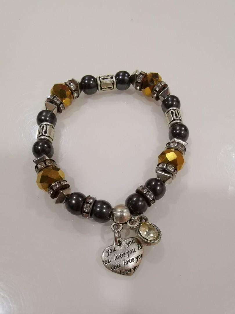 Assorted accessories (Category: Other Accessories) located in Singapore. Submitted by modestyinline (Listing ID 281483645, Image 5). Description: Assorted Bracelets & Rings 1 for $3 2 for $5 - Rose Gold Ring (Size 8) - Gold Ring (Size 7) - Blue Cat's Eye Bracelet - Black Beads with Girl Charm - Black Beads & Yellow Crystals with Heart Charm - Black Beads & Purple Crystals with Couple Heart Charm - Purple Crystal Bracelet with Heart Charm - Baby B