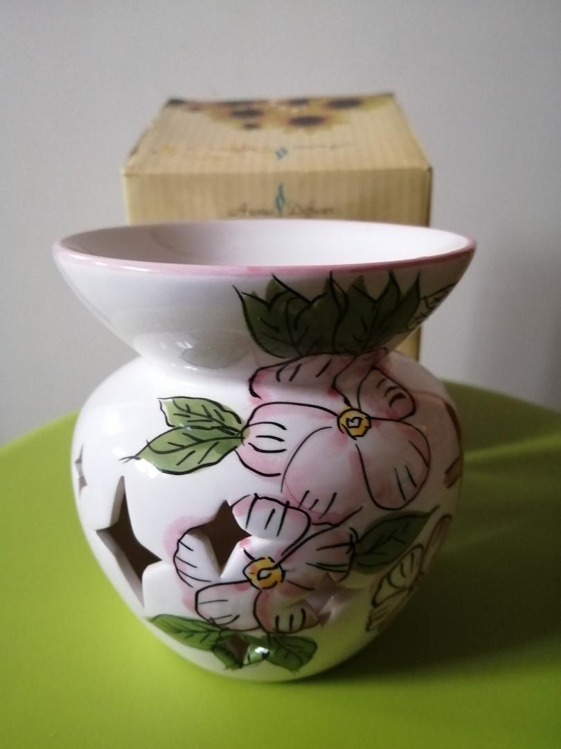 Aroma essense Diffuser (Category: Lighting) located in Singapore. Submitted by bluedanude (Listing ID 281818601, Image 1). Description: BNIB essence burner for yr home environment with design.Self collect only.Height 4" n circumference 3.5" Fragrance essence can be bought anywhere.coated ceramic inside n out,smoke mark can be wipe n clean off ez with wer cloth..