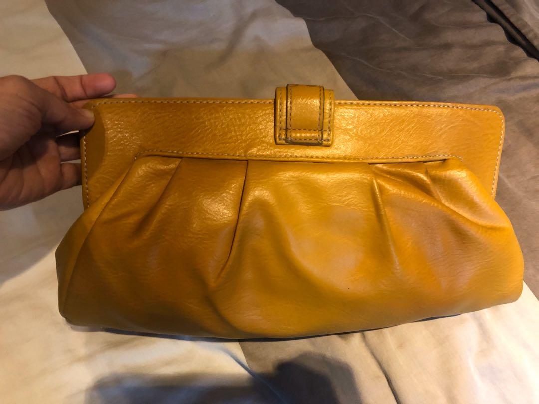 Liz Claiborne Yellow Clutch (Category: Clutches) located in Quezon City. Submitted by evecar_cf (Listing ID 282030935, Image 2). Description: Elegant Liz Claiborne mustard yellow leather clutch. Roomy enough to accommodate wallet, mobile phone, vanity kit, keys, etc. Perfect for casual wear, semi formal and formal wear. .