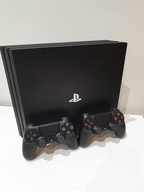 playstation 4 pro with 2 controllers