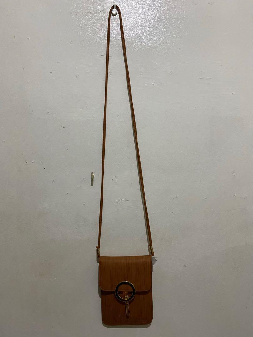 Small sling bag (Category: Cross-body Bags) located in Paranaque City. Submitted by closedcycle (Listing ID 1040880332, Image 3). Description: It has a very nice brown color It was a gift to me but it was never used .