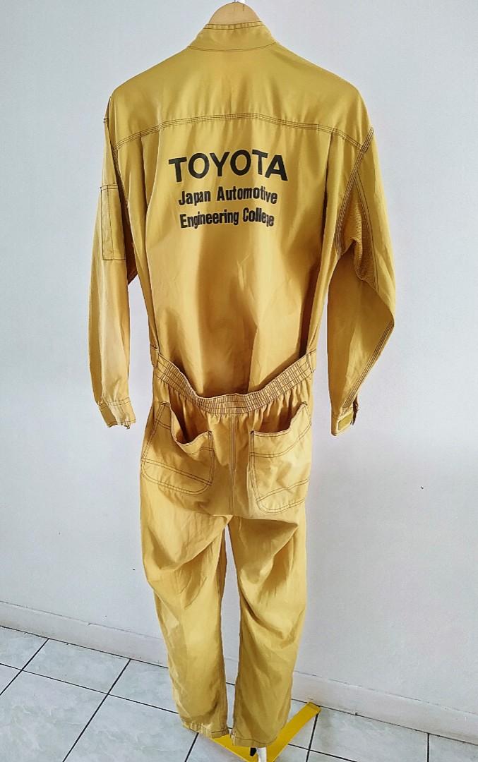 Nice Sexy Woman Mechanic Holding Wrench. Girl Weared In Yellow Work Overalls  And Grey Uplift Standing Over The Factory Stock Photo, Picture and Royalty  Free Image. Image 59583098.