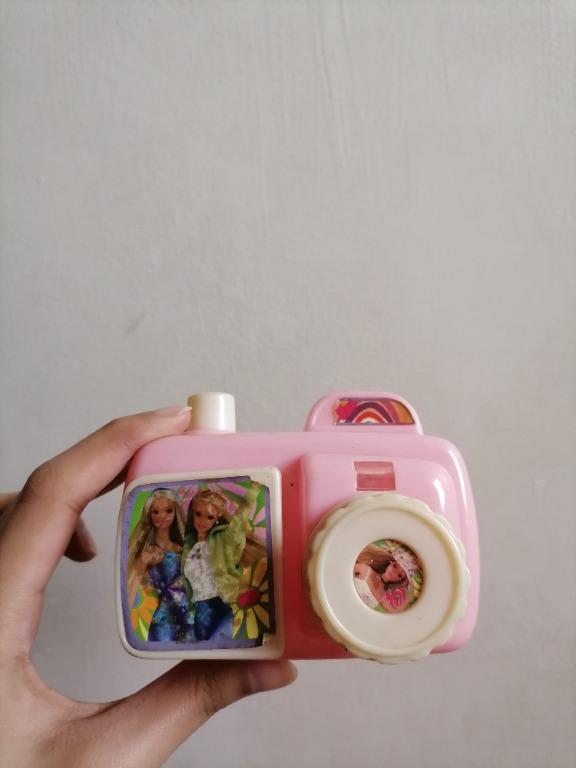 Pink Barbie Camera Toy (Category: Cameras) located in San Mateo. Submitted by Babyfume (Listing ID 1042601067, Image 2). Description: great quality BOUGHT IN THE MIDDLE EAST GOOD AS NEW the button for 'picture taking' is fully functional makes camera clicking noises a neck strap or lace can be added on the side the round knob is for zooming the picture no damage, no stains can be used for decor on kids room or paper weight message for more detail