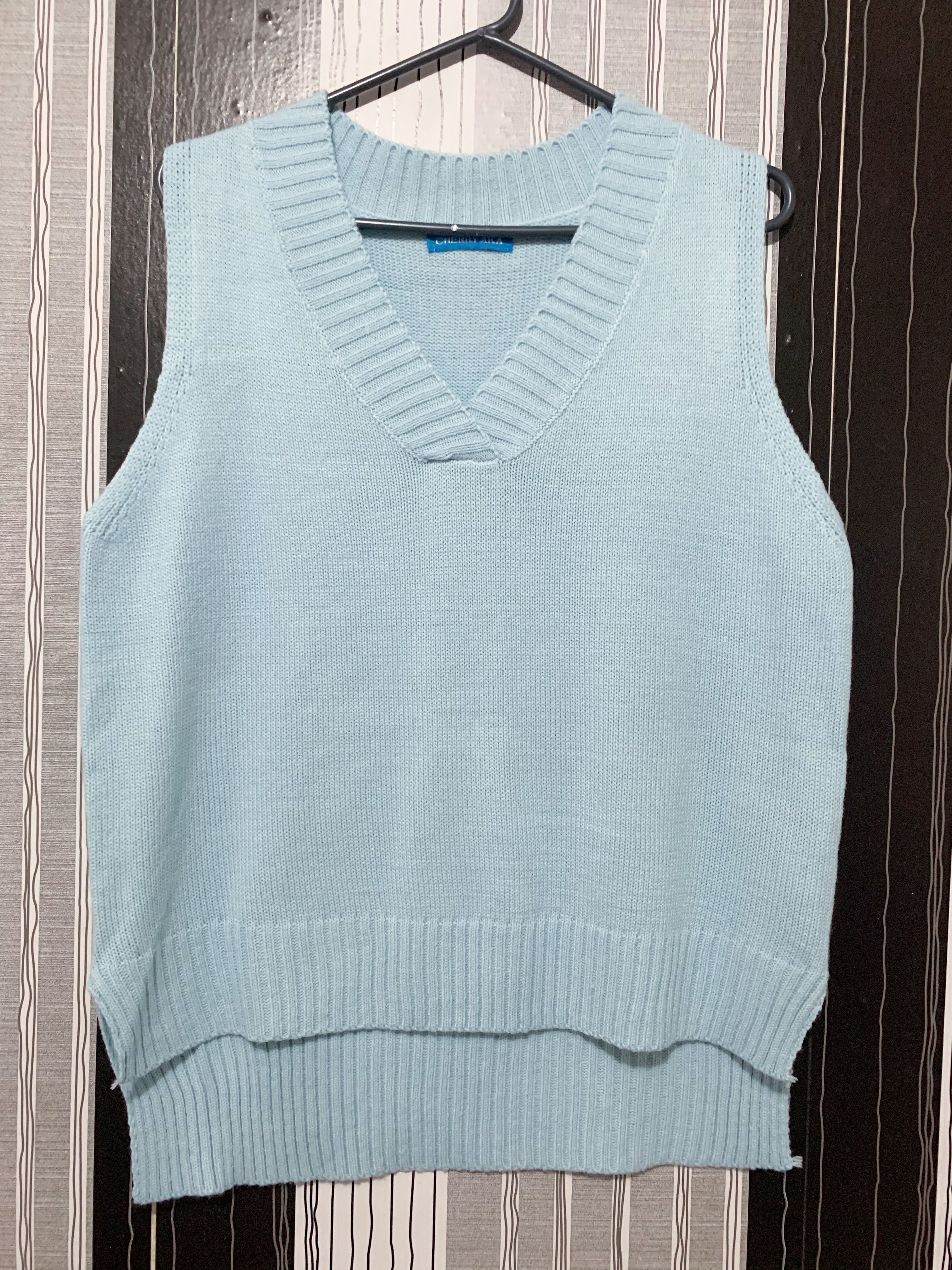 teal sweater vest
