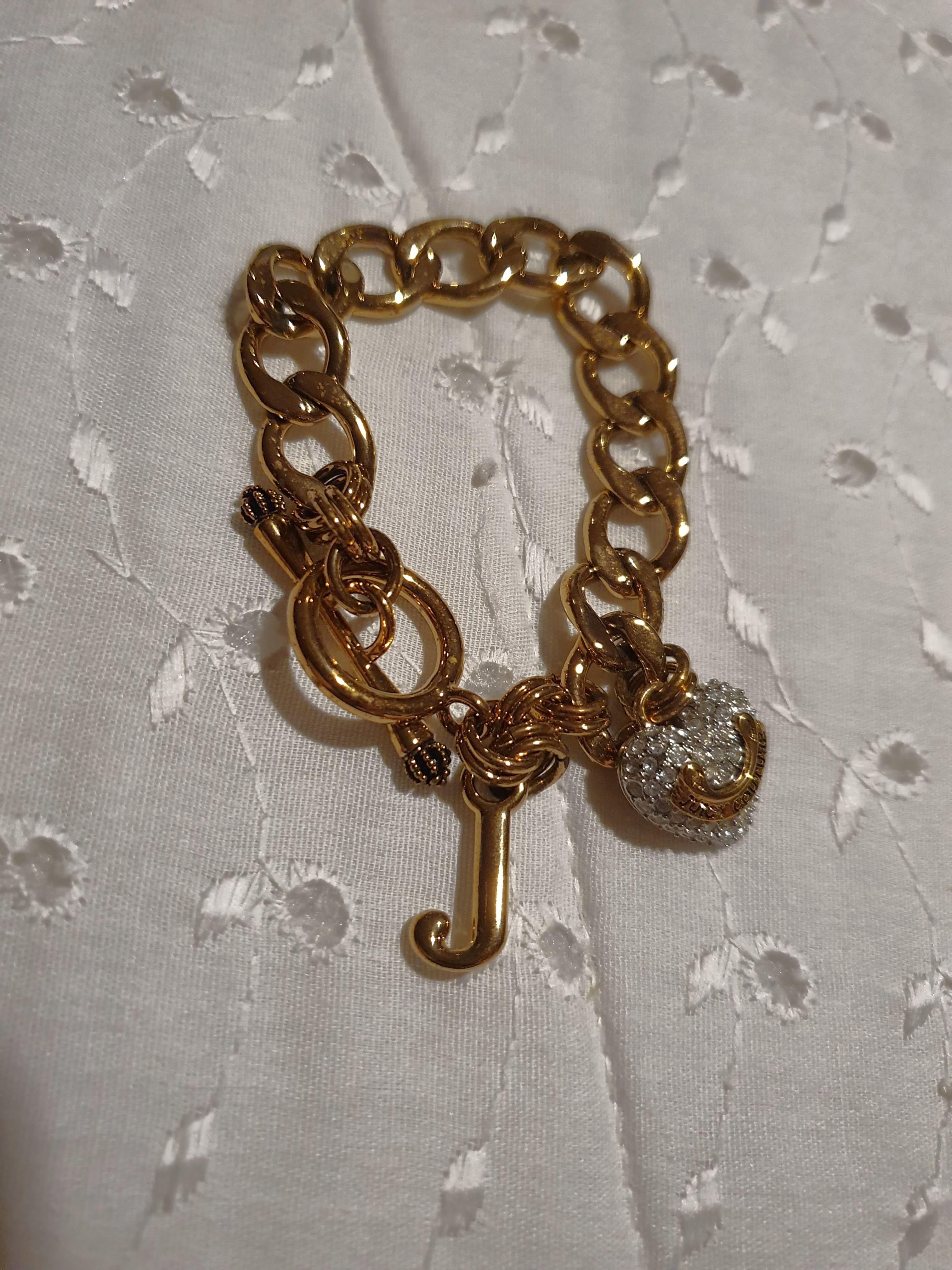 Juicy Couture Gold ID Bracelet (Category: Sneakers & Footwear) located in Makati City. Submitted by AnnaK (Listing ID 1042745962, Image 2). Description: Never Been Used Gold Plated ID Bracelet with Cubic Zirconia Heart Charm and J initial Charm. 7inches in length. Very feminine and dainty💫.