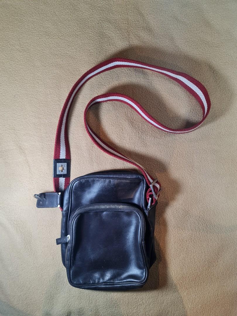 Bally Brown Leather Crossbody Bag (Category: Luxury Bags & Wallets) located in Cagayan de Oro. Submitted by dg_great_finds (Listing ID 1044864891, Image 1). Description: Here we have a stunning crossbody bag from Swiss luxury fashion house Bally. This is a perfect bag for travel as it csn hold passports, wallets and cellphones. The bag is made of genuine leather while the strap is in the iconic red and white stripes of the Swiss flag. Lock is mis