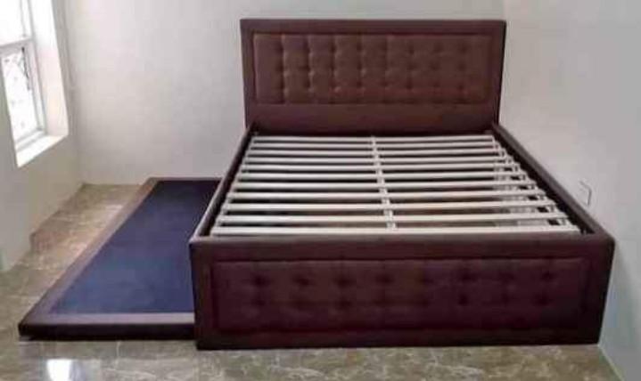 Queen bed with pull out (Category: Bed Frames & Mattresses) located in Pasay City. Submitted by cherry_nicole (Listing ID 1040163182, Image 1). Description: queen bed frame with single pull out brown color padded headboard free delivery and assemble with in metro manila cash on delivery malaysian wood.