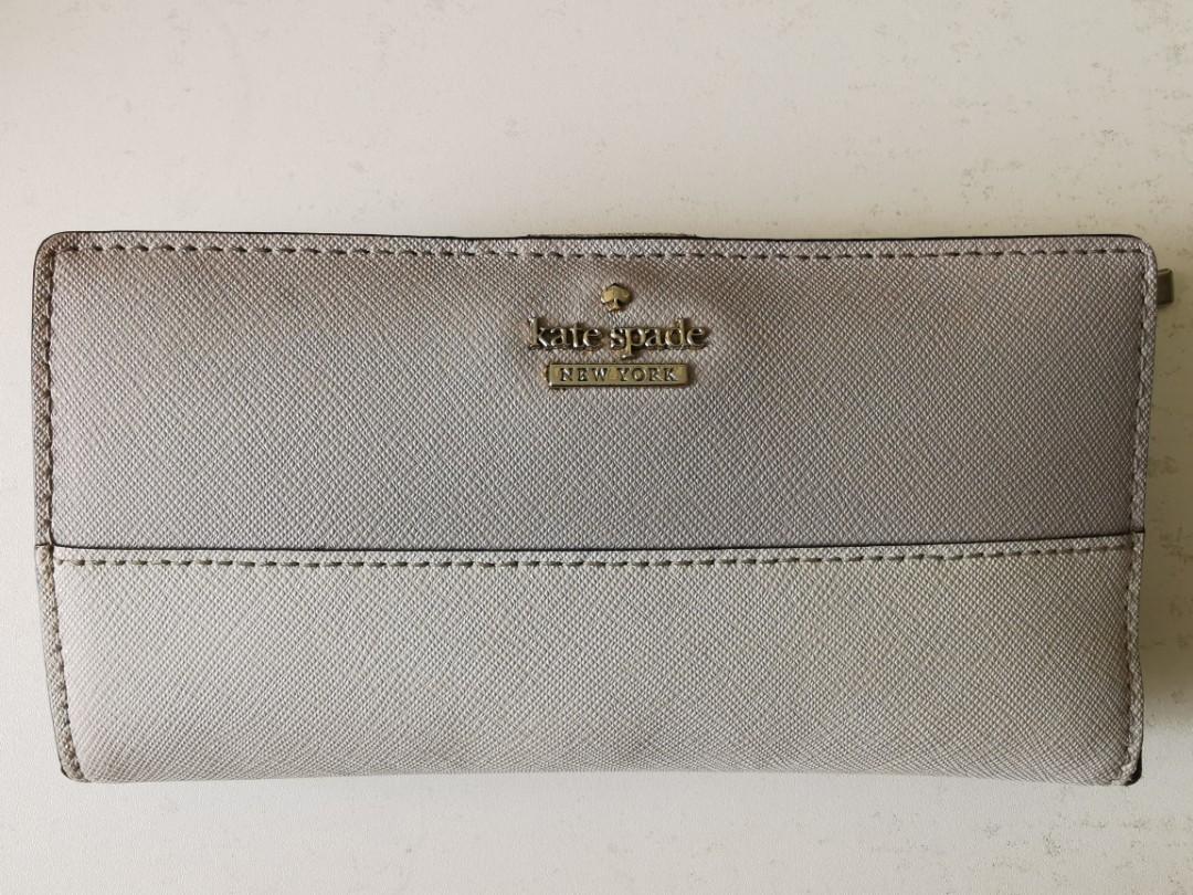 Kate Spade Slim Bifold Wallet (Soft Taupe) (Category: Luxury Bags & Wallets) located in Paranaque City. Submitted by mljboutique (Listing ID 1048876209, Image 3). Description: saffiano pvc two way spade jacquard lining 3.5" h x 6.7" w metal pinmount logo large wallet with snap closure 12 cc slots id window 4 slip pockets zip pocket (on back).