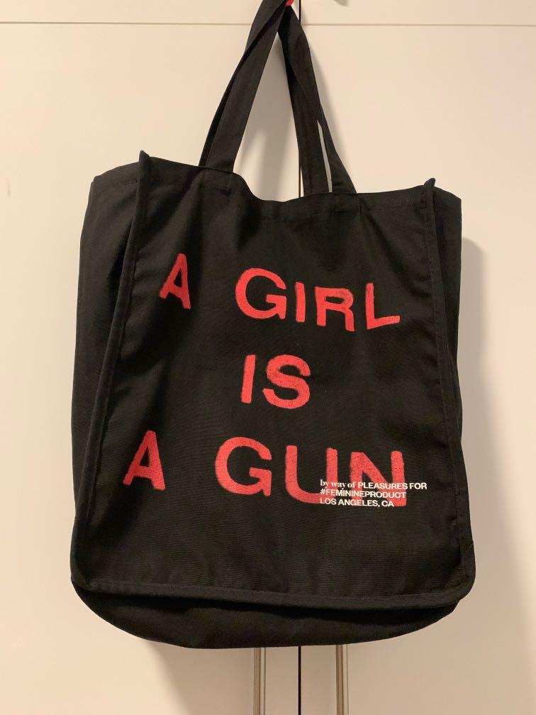 A girl is top a gun tote