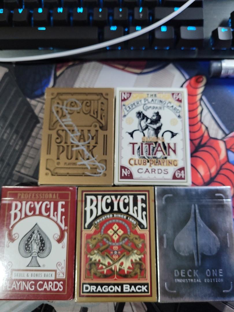 Assorted playing cards (Category: Interactive Toys) located in Singapore. Submitted by muhdhaiqal1121 (Listing ID 1049385653, Image 1). Description: Assorted playing cards for sale. Brand New (Unsealed) - BICYCLE STEAMPUNK (signed by Asad of 52Kards) - $20 Brand New (Sealed) - TITAN - $15 - BICYCLE SKULL & BONES BACK - $12 - BICYCLE DRAGON BACK - $12 - DECK ONE - $12 Opened and used - VIRTUOSO (SOLD) - DECK ONE - $5 - BICYCLE STEAMPUNK BANDITS - 